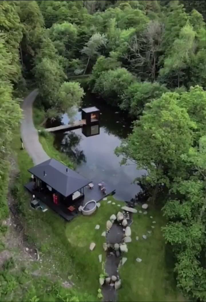 The bathhouse and its pond at dusk, seen from above